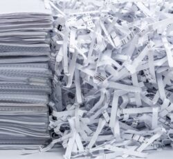 A,pile,of,papers,next,to,scraps,from,destroyed,company