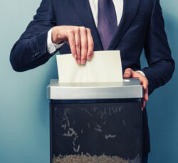 A,businessman,is,shredding,important,documents
