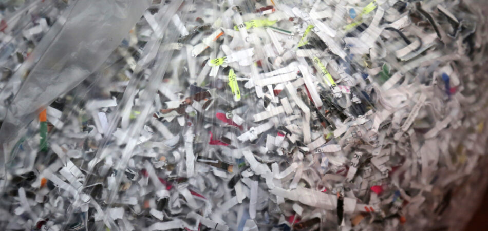 Shredded,paper.,a,clear,trash,bag,of,confetti,shredded,paper